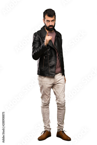 Handsome man with beard frustrated and pointing to the front over isolated white background