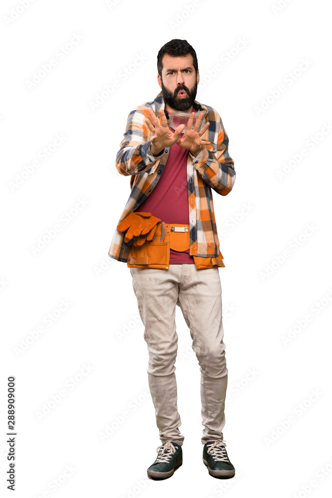 Craftsmen man nervous stretching hands to the front over isolated white background Craftsmen man nervous stretching hands to the front over isolated white background