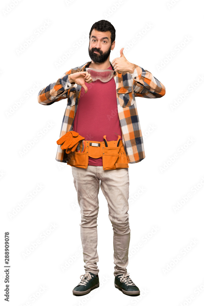 Craftsmen man making good-bad sign. Undecided between yes or not over isolated white background Craftsmen man making good-bad sign. Undecided between yes or not over isolated white background