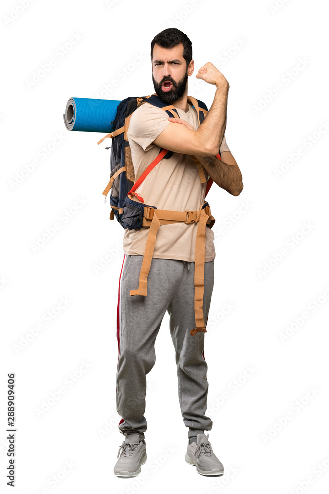 Hiker man doing strong gesture over isolated white background Hiker man doing strong gesture over isolated white background