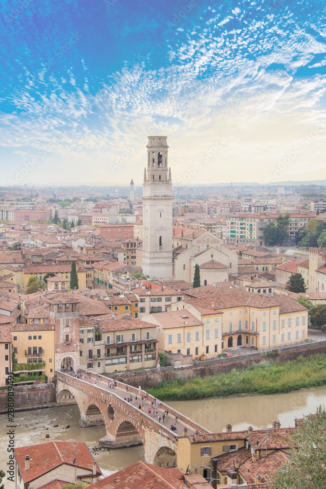 Beautiful view of the Lamberti Tower and Ponte Pietra on the banks of the Adige River in Verona, Italy