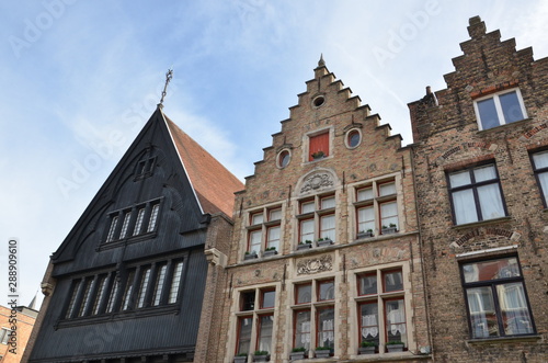 Bruges, Belgium. Image with Rozenhoedkaai in Brugge, Dijver river canal twilight and Belfort (Belfry) tower. © Dilya