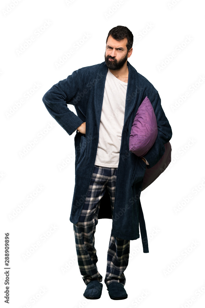 Man with beard in pajamas angry over isolated white background Man with beard in pajamas angry over isolated white background