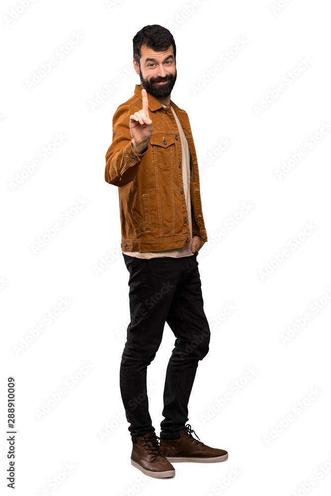 Handsome man with beard showing and lifting a finger over isolated white background Handsome man with beard showing and lifting a finger over isolated white background