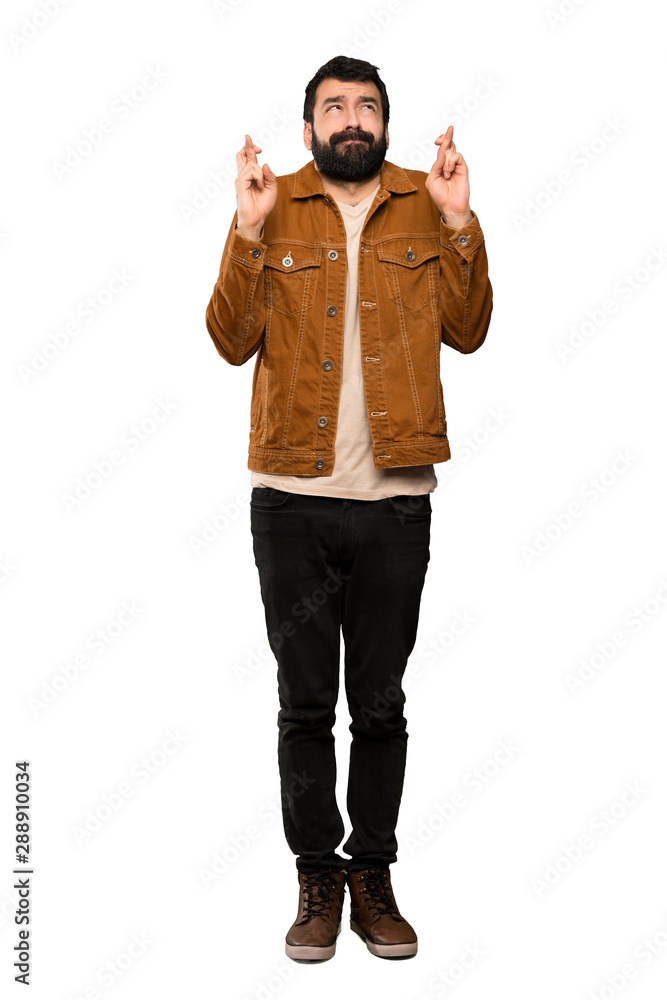 Handsome man with beard with fingers crossing and wishing the best over isolated white background Handsome man with beard with fingers crossing and wishing the best over isolated white background