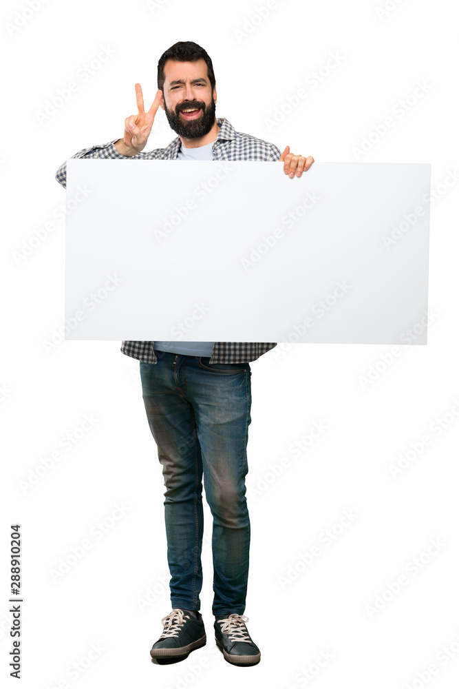 Happy Handsome man with beard holding an empty placard Happy Handsome man with beard holding an empty placard