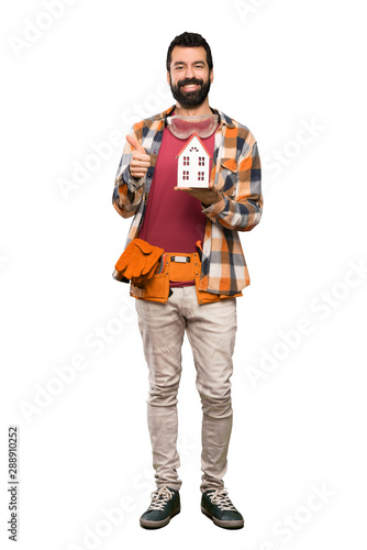 Happy Craftsmen man holding a little house