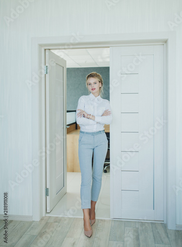 full-length portrait of a blonde woman in the office