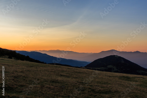 Sunrise from a valley watching the mountains with a little fog. Nature concept © Rafa