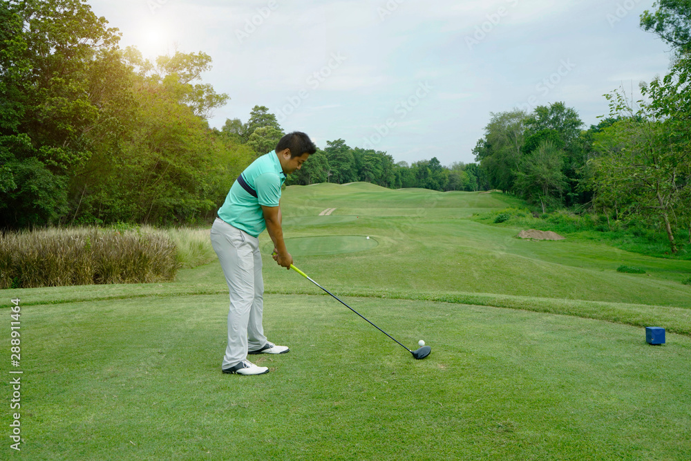 Fototapeta premium Blurred golfer playing golf in beautiful golf course in the evening golf course with sunshine in thailand