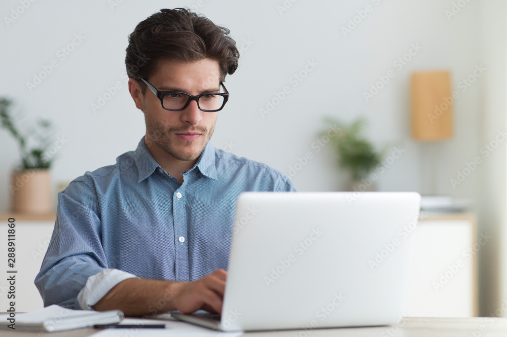 Serious Businessman Working At Laptop In Office Serious Businessman Working At Laptop In Office