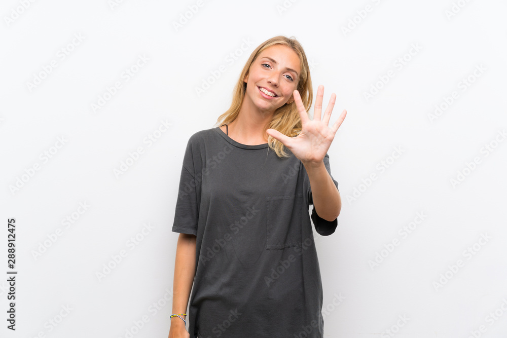 Blonde young woman over isolated white background counting five with fingers Blonde young woman over isolated white background counting five with fingers