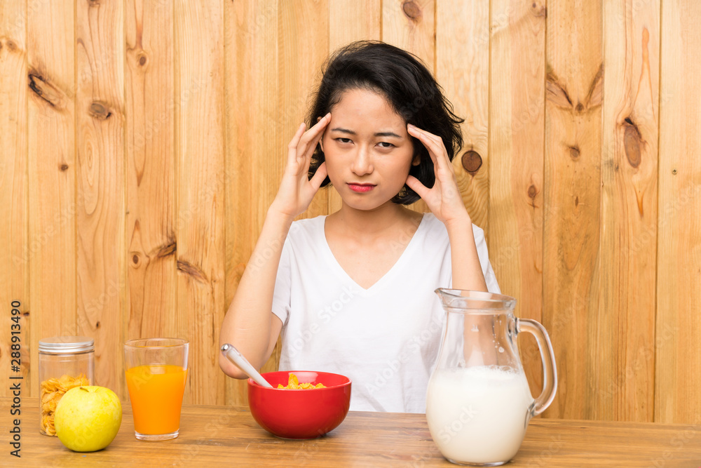 Asian young woman having breakfast milk unhappy and frustrated with something. Negative facial expression Asian young woman having breakfast milk unhappy and frustrated with something. Negative facial expression