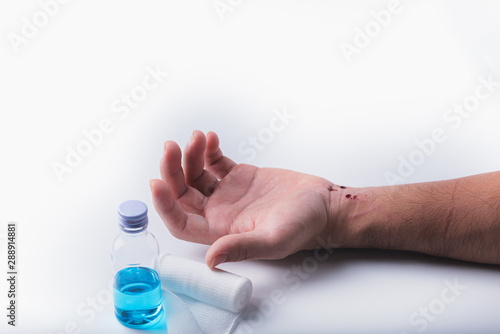 Man hand has a wound and bleeding on his wrist isolated on white background.First aid concept
