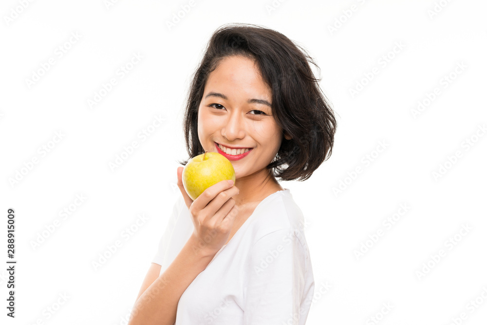 Asian young woman over isolated background with an apple Asian young woman over isolated background with an apple