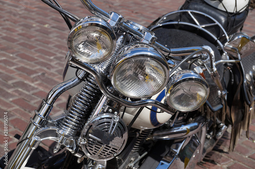 Front view of a motorcycle lamp. A motorcycle full of chrome elements, chopper type.
