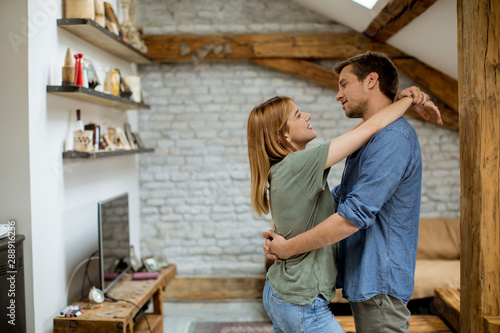 Happy couple hugging in the loft apartment © BGStock72