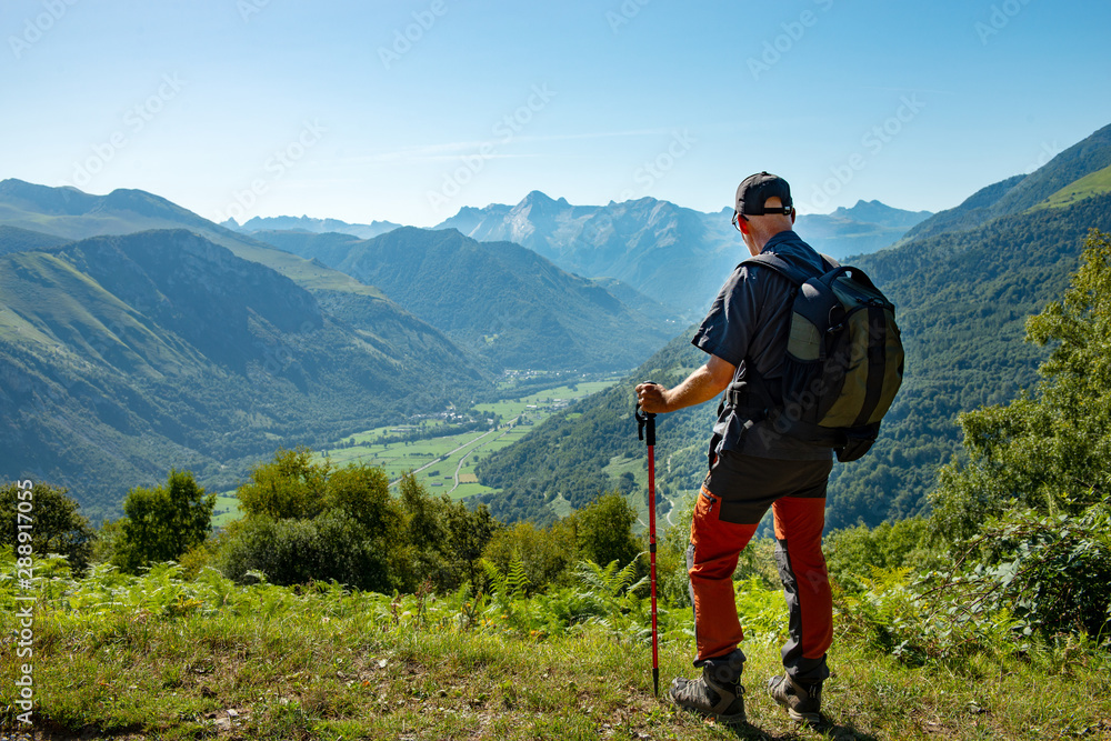 man with backpack hiking in Pyrenees Mountains