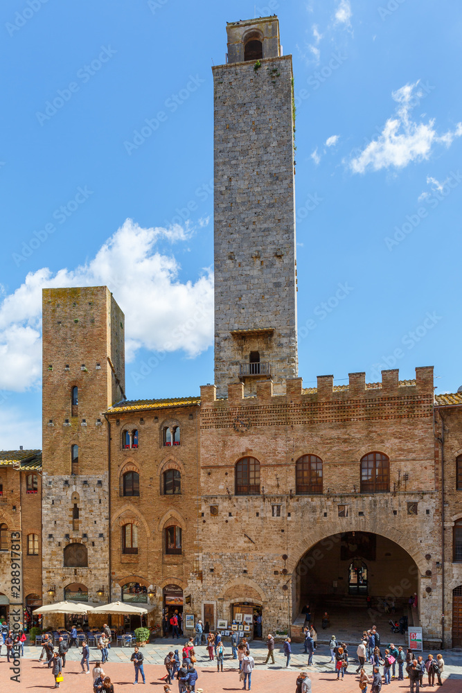 Tourists at the piazza duomo in San Gimignano, Italy