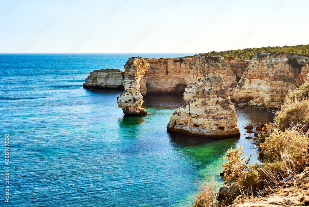 Rocks and sandy beach in Portugal, Atlantic coast, Algarve.