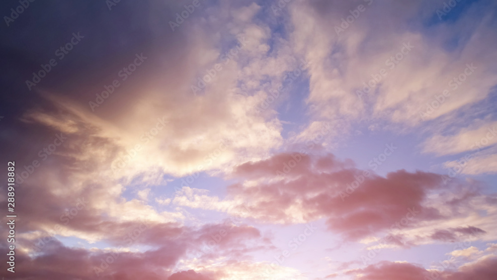 beautiful pink sunset and sky with clouds and sunlight