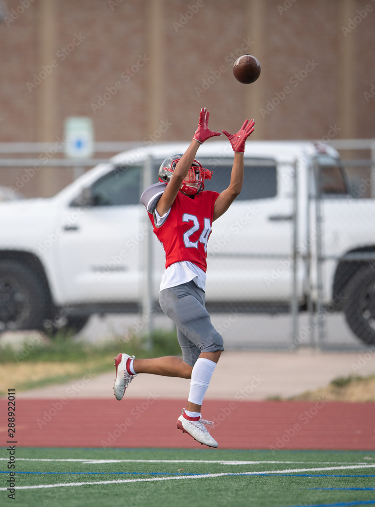 Fototapeta premium Great action photos of high school football players making amazing plays during a football game