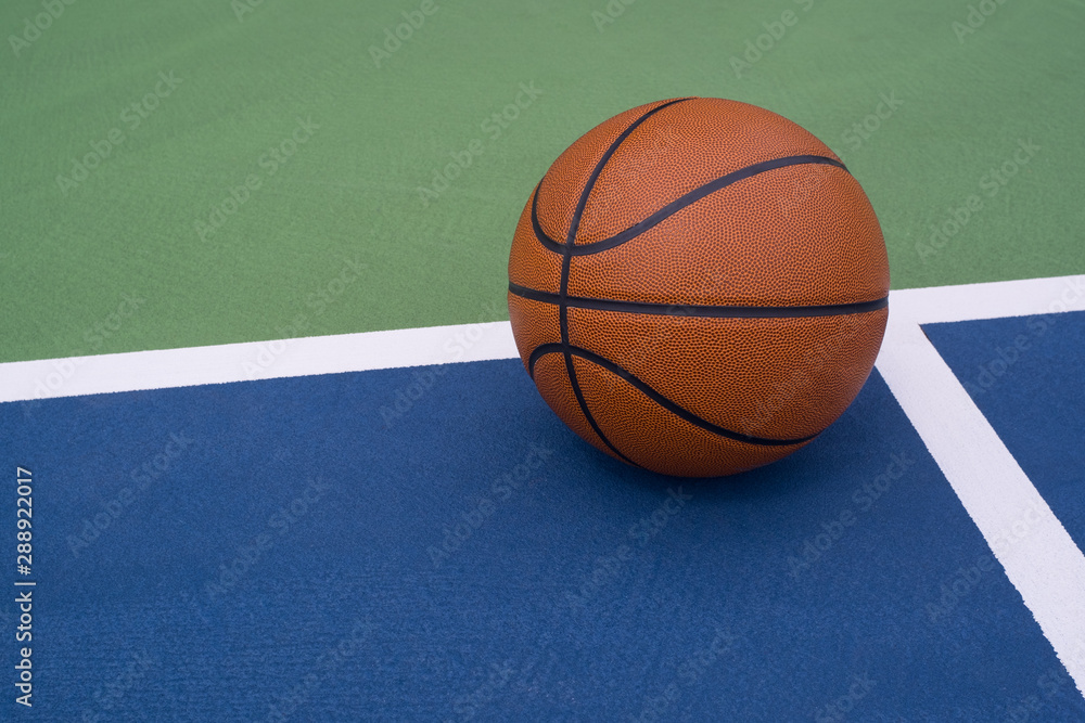 Fototapeta premium Basketball rests on court