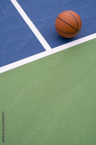 Basketball rests on court