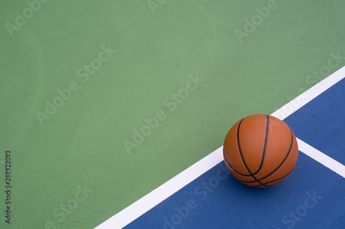 Basketball rests on court