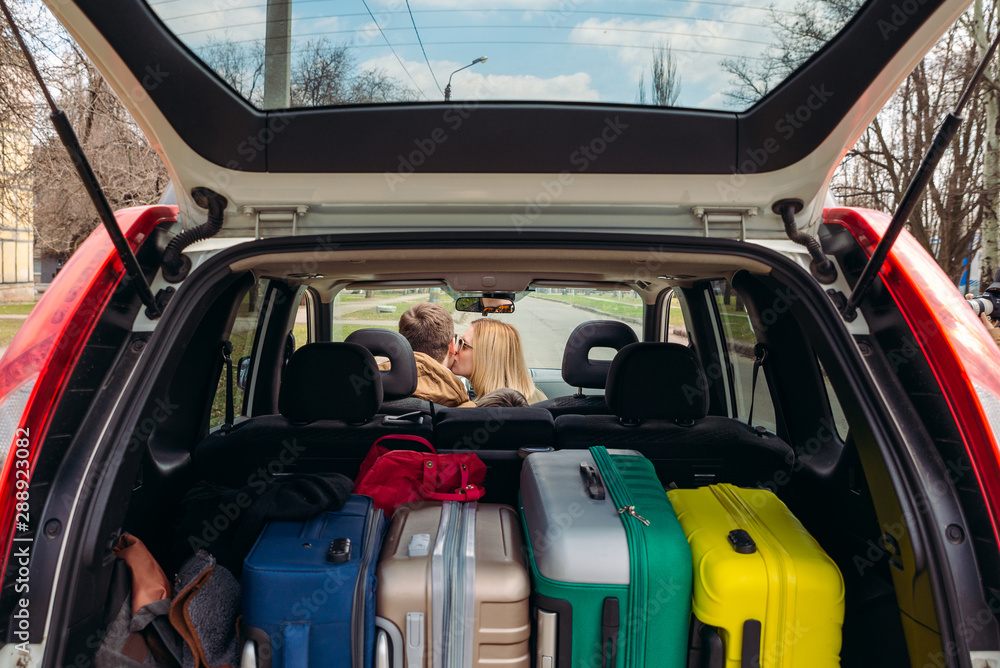 cute couple ready for car travel kiss in cheek cute couple ready for car travel kiss in cheek