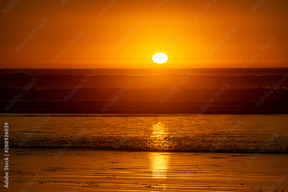 Last sunlight of the day with sunset over the Atlantic Ocean from Agadir beach, Morocco, Africa Last sunlight of the day with sunset over the Atlantic Ocean from Agadir beach, Morocco, Africa