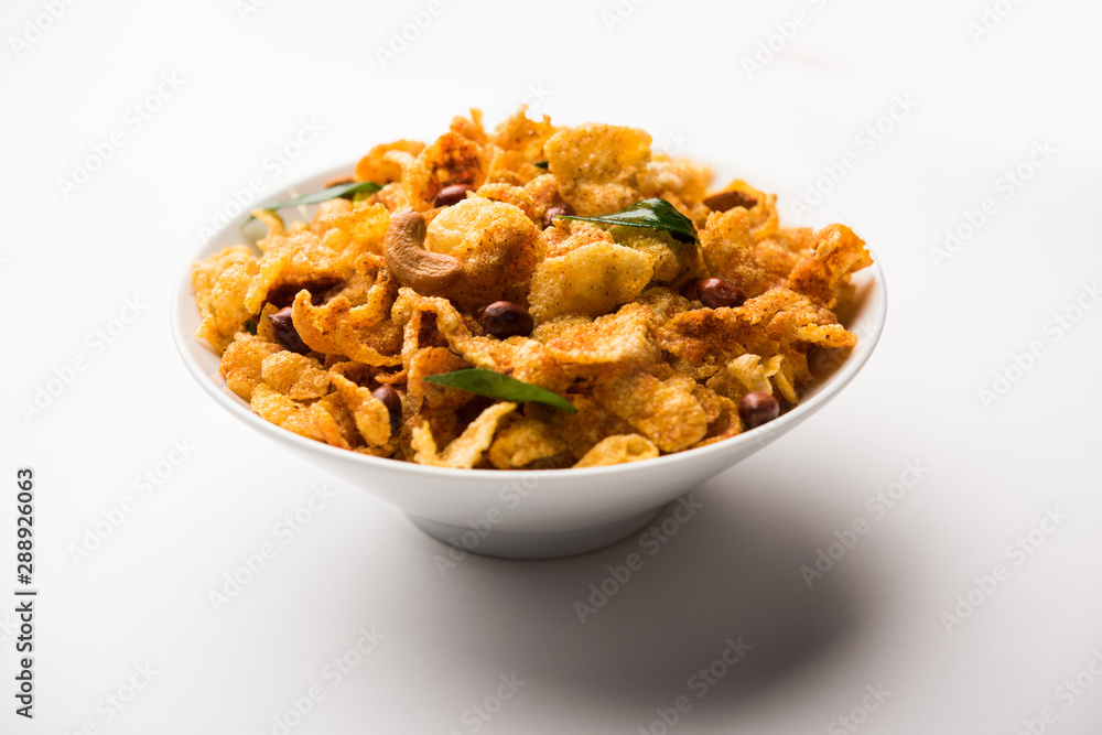 Cornflake Chivda or Corn Chiwda loaded with peanuts and Cashew. Served in a bowl. selective focus Cornflake Chivda or Corn Chiwda loaded with peanuts and Cashew. Served in a bowl. selective focus