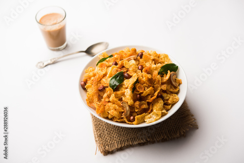 Cornflake Chivda or Corn Chiwda loaded with peanuts and Cashew. Served in a bowl. selective focus photo