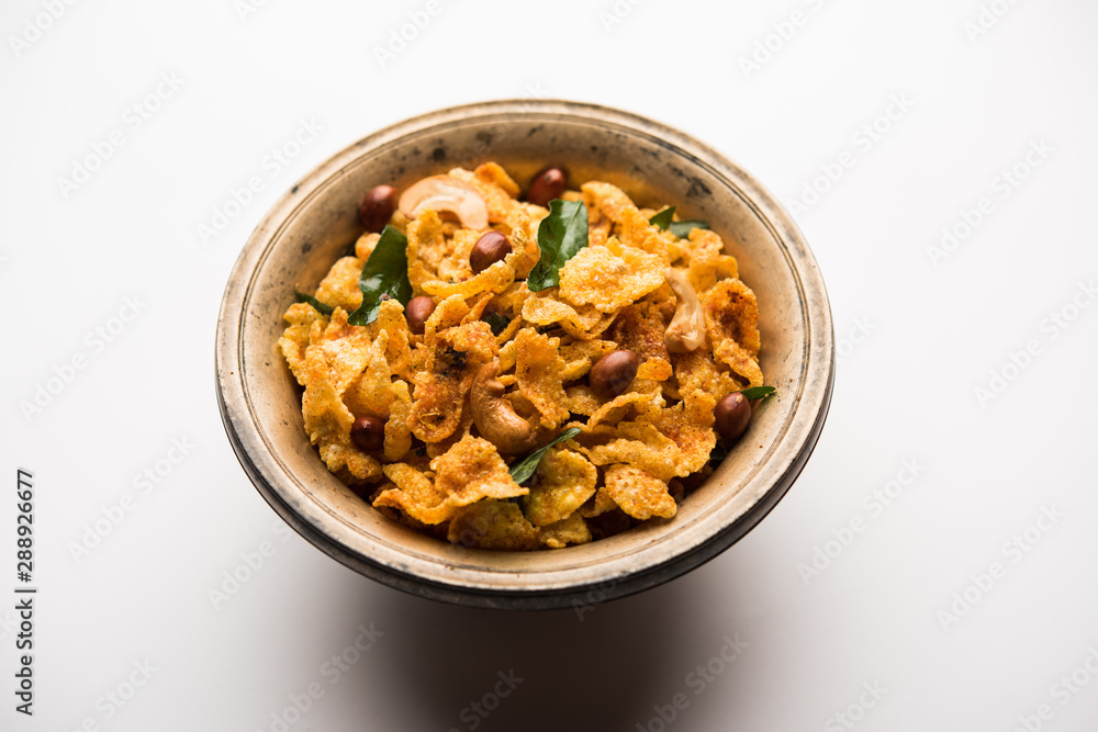 Cornflake Chivda or Corn Chiwda loaded with peanuts and Cashew. Served in a bowl. selective focus Cornflake Chivda or Corn Chiwda loaded with peanuts and Cashew. Served in a bowl. selective focus