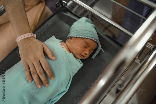 newborn baby sleeping on the crib in the hospital