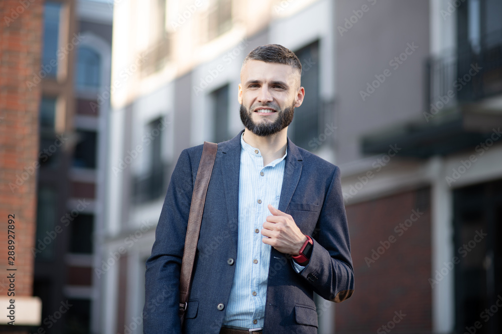 Young man wearing smart watch walking to the office Young man wearing smart watch walking to the office