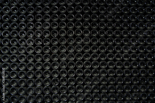 Big stock of wine bottles laying in wine cellar, Bordeaux winery, France