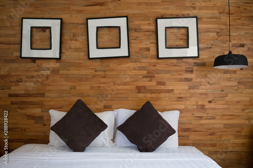 White bed in a wooded bedroom