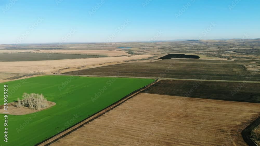 Aerial shot of green field in deserted area Aerial shot of green field in deserted area