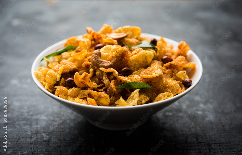 Cornflake Chivda or Corn Chiwda loaded with peanuts and Cashew. Served in a bowl. selective focus Cornflake Chivda or Corn Chiwda loaded with peanuts and Cashew. Served in a bowl. selective focus