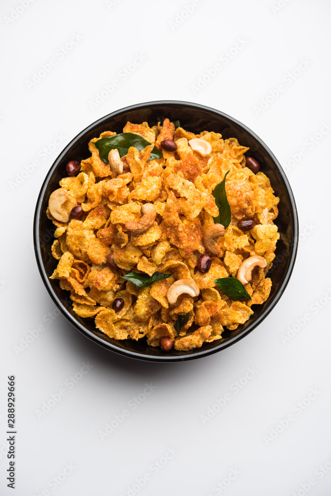 Cornflake Chivda or Corn Chiwda loaded with peanuts and Cashew. Served in a bowl. selective focus Cornflake Chivda or Corn Chiwda loaded with peanuts and Cashew. Served in a bowl. selective focus