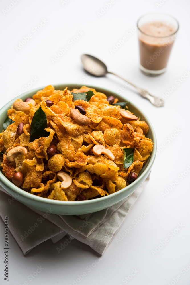 Cornflake Chivda or Corn Chiwda loaded with peanuts and Cashew. Served in a bowl. selective focus Cornflake Chivda or Corn Chiwda loaded with peanuts and Cashew. Served in a bowl. selective focus