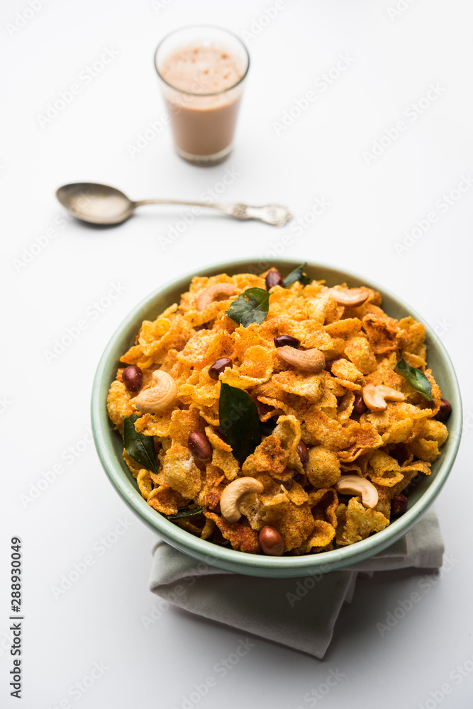 Cornflake Chivda or Corn Chiwda loaded with peanuts and Cashew. Served in a bowl. selective focus Cornflake Chivda or Corn Chiwda loaded with peanuts and Cashew. Served in a bowl. selective focus