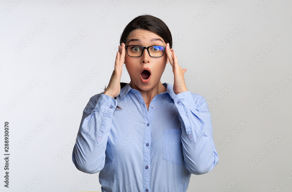 Shocked Businesswoman Looking At Camera Over White Studio Background Shocked Businesswoman Looking At Camera Over White Studio Background