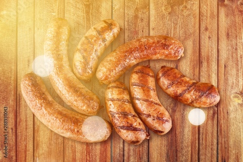 Roasted sausages on white background photo