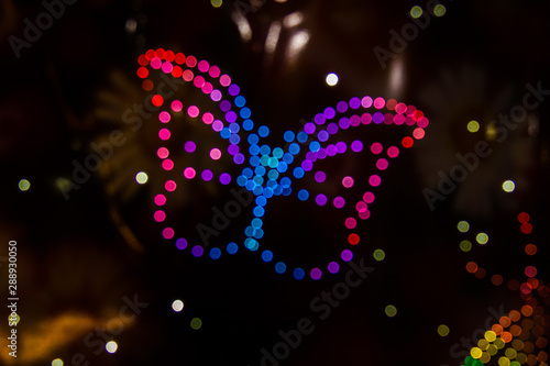 A butterfly formed by LED lights and the Bokeh effect in various colors. © Jason Yoder