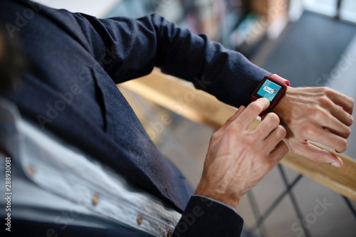 Businessman using smart watch receiving e-mail from secretary © zinkevych