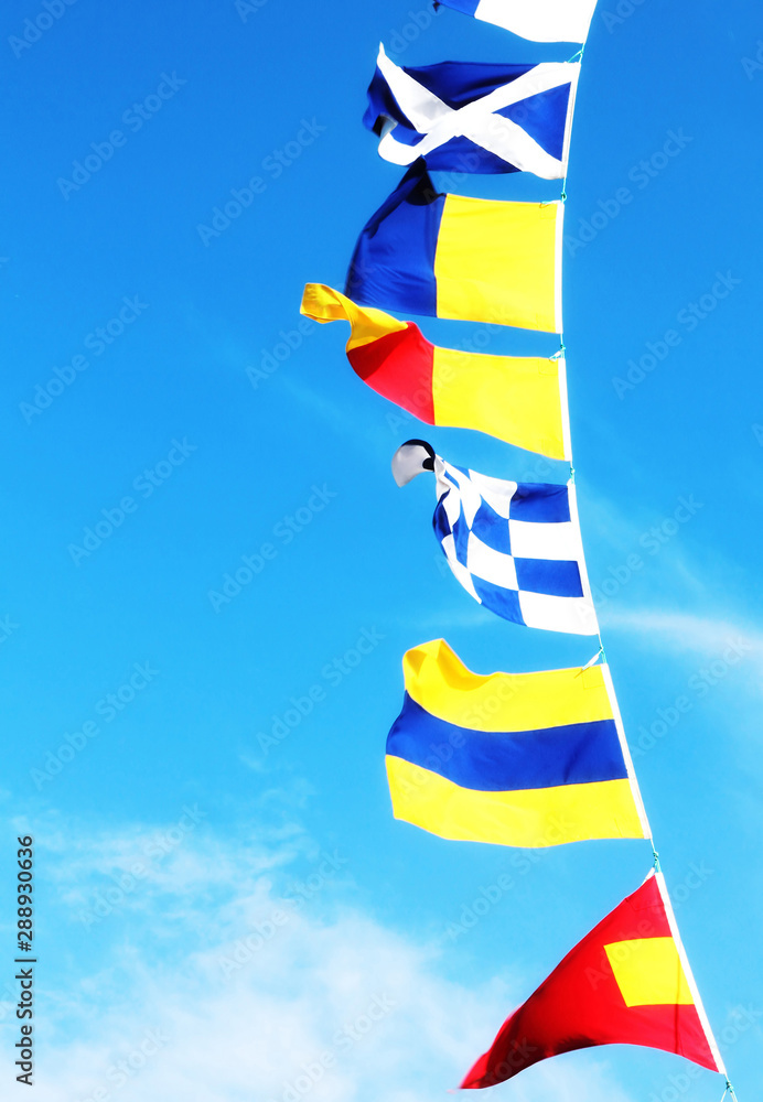 Marine signal flags on a clear blue sky background. Marine signal flags on a clear blue sky background.