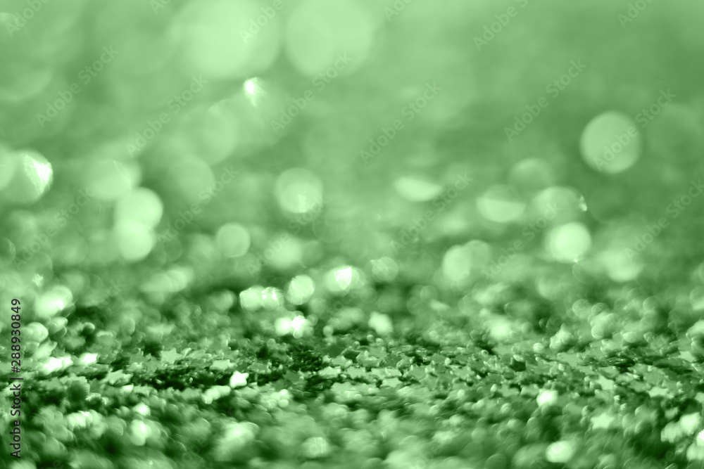 Glitters on mint blur backdrop. Trend color of 2020. Decorative Christmas and New Year party background. Festive template. Greeting card with copy space. Colorful tinsel. Glitter texture Glitters on mint blur backdrop. Trend color of 2020. Decorative Christmas and New Year party background. Festive template. Greeting card with copy space. Colorful tinsel. Glitter texture