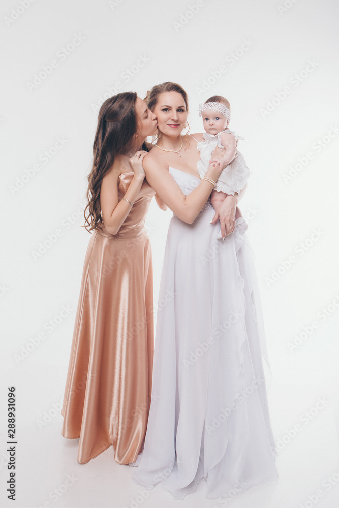 wedding fashion concept for women of all ages. A group of women in long evening dresses on a white background